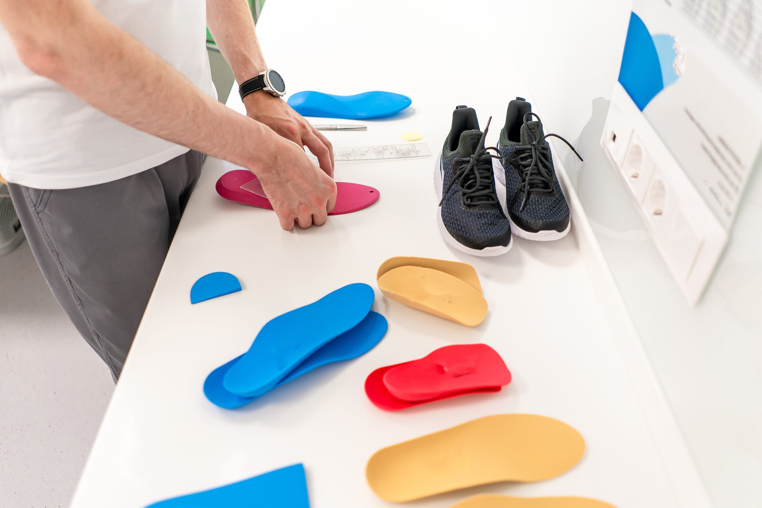 Orthopedic insole. The orthopedist works with the patient. Orthopedic clinic. Choice of insoles in an orthopedic clinic. The orthopedist offers the insole to the patient Foot care